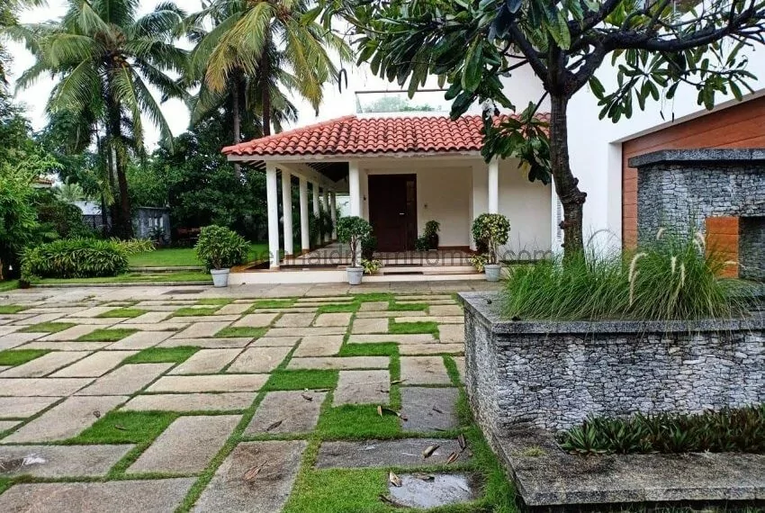 Entrance to the villa with a neat garden